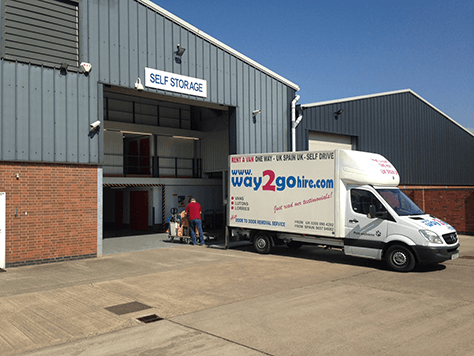 Man unloading a hired furniture removal van into storage